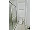 Updated bathroom with glass shower enclosure, toilet, and towel bar at 5463 Forest East Ln, Stone Mountain, GA 30088