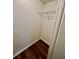Small, white closet with wood-look floor and single wire shelf at 5463 Forest East Ln, Stone Mountain, GA 30088