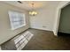 Bright dining room featuring crown molding, fresh paint and new carpeting at 5463 Forest East Ln, Stone Mountain, GA 30088