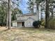 Charming two-story home with neutral siding, attached garage and mature trees at 5463 Forest East Ln, Stone Mountain, GA 30088