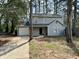 Charming two-story home featuring gray siding, attached garage, and a well-maintained front yard at 5463 Forest East Ln, Stone Mountain, GA 30088