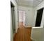 Hallway with wood floor leading to bedrooms and bath at 5463 Forest East Ln, Stone Mountain, GA 30088
