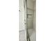 Walk-in shower featuring white tile, built-in niche, gray penny tile flooring, and frameless sliding glass door at 5463 Forest East Ln, Stone Mountain, GA 30088