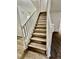 Staircase with wood treads, white risers, and white railing at 5463 Forest East Ln, Stone Mountain, GA 30088