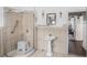 Traditional bathroom featuring a pedestal sink, walk-in shower with a seat, and a view to an open doorway at 799 Moreland Se Ave, Atlanta, GA 30316