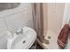 Small bathroom features a modern sink, gray tiled walls, and a shower with a gray curtain at 799 Moreland Se Ave, Atlanta, GA 30316