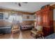 Bedroom with wood paneled walls featuring twin beds and comfortable armchairs at 799 Moreland Se Ave, Atlanta, GA 30316