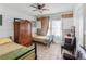 Bright bedroom with tiled floor, ceiling fan, two twin beds, and an antique wardrobe at 799 Moreland Se Ave, Atlanta, GA 30316