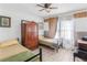 Cozy bedroom with twin beds, wood accent walls, tiled flooring, and a classic wardrobe at 799 Moreland Se Ave, Atlanta, GA 30316