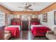 Bedroom with two twin beds featuring tiled floor, a ceiling fan and wood-paneled accent wall at 799 Moreland Se Ave, Atlanta, GA 30316