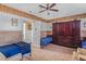 Bedroom with wood paneled walls featuring twin beds and coordinating armoires at 799 Moreland Se Ave, Atlanta, GA 30316