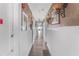 Long hallway with hardwood floors and several doors in a commercial property, lit by sconces at 799 Moreland Se Ave, Atlanta, GA 30316