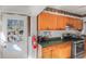 Functional kitchen with wood cabinets, tiled backsplash, and a door to the outdoors for natural lighting at 799 Moreland Se Ave, Atlanta, GA 30316