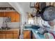 Modest kitchen with wooden cabinets, a double basin sink, a window, and hanging pots and pans at 799 Moreland Se Ave, Atlanta, GA 30316