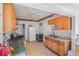 Well-lit kitchen with tile floors, white appliances, and wooden cabinets and a small eat-in area at 799 Moreland Se Ave, Atlanta, GA 30316
