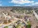 Aerial view of a house nestled among trees with a clear view of the neighborhood and surrounding area at 1600 Spring Harbor Ct, Lilburn, GA 30047