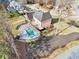 An eye-level view of the property's well-maintained lawn, landscaped areas, and pristine in-ground pool at 1600 Spring Arbor Sw Ct, Lilburn, GA 30047