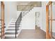 Traditional foyer with open staircase, wood floors, and natural light at 1600 Spring Arbor Sw Ct, Lilburn, GA 30047