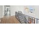 Open hallway with staircase and contemporary chandelier and luxury vinyl plank flooring at 1600 Spring Arbor Sw Ct, Lilburn, GA 30047