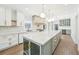Bright, open kitchen with an oversized island, marble countertops, and stainless steel appliances at 1600 Spring Arbor Sw Ct, Lilburn, GA 30047