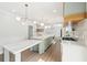 Bright kitchen boasts white marble counters, state of the art appliances, and modern lighting fixtures at 1600 Spring Arbor Sw Ct, Lilburn, GA 30047