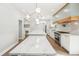 Expansive kitchen featuring a large island, stainless steel appliances, and modern lighting fixtures at 1600 Spring Arbor Sw Ct, Lilburn, GA 30047