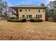 Beautiful backyard view of the home featuring a deck, covered patio, and expansive lawn area at 6111 Sequoia Ln, Douglasville, GA 30135