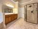 Bright bathroom featuring a glass shower, double vanity, and a neutral color palette at 6111 Sequoia Ln, Douglasville, GA 30135