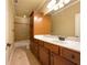 Neutral bathroom featuring a shower-tub combo, a large mirror, and wood cabinetry at 6111 Sequoia Ln, Douglasville, GA 30135