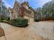 Spacious driveway leading to a three-car garage, surrounded by lush greenery at 6111 Sequoia Ln, Douglasville, GA 30135
