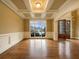 Living room with coffered ceilings, hardwood floors, and a wall of windows at 6111 Sequoia Ln, Douglasville, GA 30135