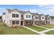 New townhomes boast modern exteriors with black shutters, brick accents, and well-manicured lawns at 436 Reflection Dr # 15, Stockbridge, GA 30281