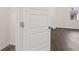Hallway has hardwood floors with a three panel door at 436 Reflection Dr # 15, Stockbridge, GA 30281