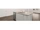 Close-up view of kitchen island featuring granite countertop, sink, and stainless steel dishwasher, showcasing functionality at 436 Reflection Dr # 15, Stockbridge, GA 30281