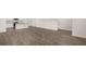 Open-concept living room features hardwood flooring and connects to the kitchen with a white island at 436 Reflection Dr # 15, Stockbridge, GA 30281