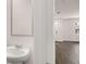 Powder room features a pedestal sink and a view into the adjacent living area and natural light at 436 Reflection Dr # 15, Stockbridge, GA 30281
