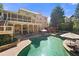 Gorgeous backyard with a large pool, spa, outdoor seating, and a covered deck perfect for relaxing and entertaining at 5120 Parkwood Oaks Ln, Smyrna, GA 30126