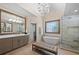 Stunning bathroom features a soaking tub, a glass shower, vanity with dual sinks and a stylish chandelier at 5120 Parkwood Oaks Ln, Smyrna, GA 30126