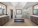 Luxurious primary bathroom with a soaking tub, walk-in shower, dual vanities, and designer lighting at 5120 Parkwood Oaks Ln, Smyrna, GA 30126