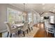 Bright dining area features a modern table set, large windows, and hardwood floors at 5120 Parkwood Oaks Ln, Smyrna, GA 30126