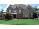 Charming two-story home with well-manicured lawn and stone and siding accents at 5120 Parkwood Oaks Ln, Smyrna, GA 30126
