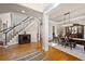 Inviting foyer featuring hardwood floors, staircase, and elegant decor leading to the dining area at 5120 Parkwood Oaks Ln, Smyrna, GA 30126