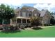 Charming front exterior showcasing stone and shingle siding, a covered porch, and lush landscaping enhancing curb appeal at 5120 Parkwood Oaks Ln, Smyrna, GA 30126