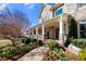 Charming front porch with stone accents, columns, and beautifully landscaped garden beds at 5120 Parkwood Oaks Ln, Smyrna, GA 30126