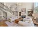 Inviting living room with hardwood floors, fireplace, and staircase leading to the upper level and a vaulted ceiling at 5120 Parkwood Oaks Ln, Smyrna, GA 30126