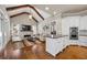 Open living space featuring hardwood floors, vaulted ceilings with wood beams, and a stone fireplace at 5120 Parkwood Oaks Ln, Smyrna, GA 30126