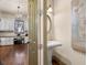 Stylish powder room featuring a pedestal sink, decorative mirror, and elegant lighting and hardwood floors at 5120 Parkwood Oaks Ln, Smyrna, GA 30126