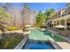 Inviting swimming pool with a hot tub, lounge chairs, and a pergola, all set in a beautifully landscaped backyard at 5120 Parkwood Oaks Ln, Smyrna, GA 30126