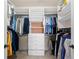 Spacious walk-in closet features ample shelving, multiple hanging rods, and convenient drawer storage at 5120 Parkwood Oaks Ln, Smyrna, GA 30126