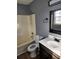 Bathroom with shower-tub combo, vanity with a single sink, and a window at 5778 Eagles Feather Ln, Riverdale, GA 30274